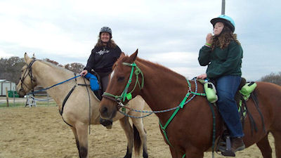 Two riders are both wearing helmets