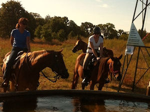 Riders at LBJ Grasslands Red Windmill stock tank for commemoration