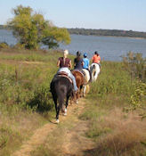 Walnut Grove Trail by Lake Grapevine, TX - 4 horseback trail riders heading to lake